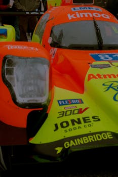 Detailed shot of a colorful racing car showing raindrops on windshield. Ideal for motorsport enthusiasts.