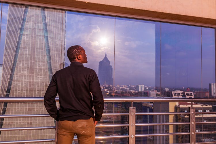 Man Standing On Outdoor Building Terrace