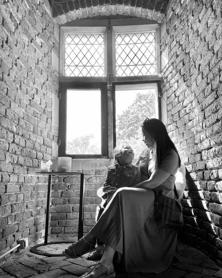 Black And White Photo Of Mother Sitting With Her Daughter 