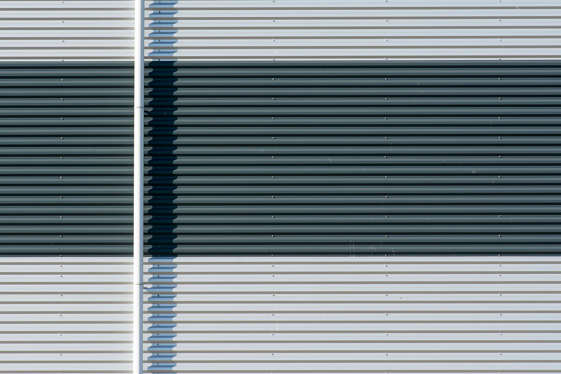Detailed view of a corrugated metal roll up door with linear patterns and textures.
