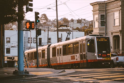 Red and White Tram on Street