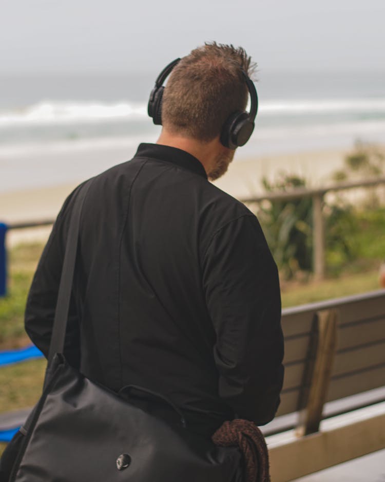 Man Wearing Headphones Walking Through Alley