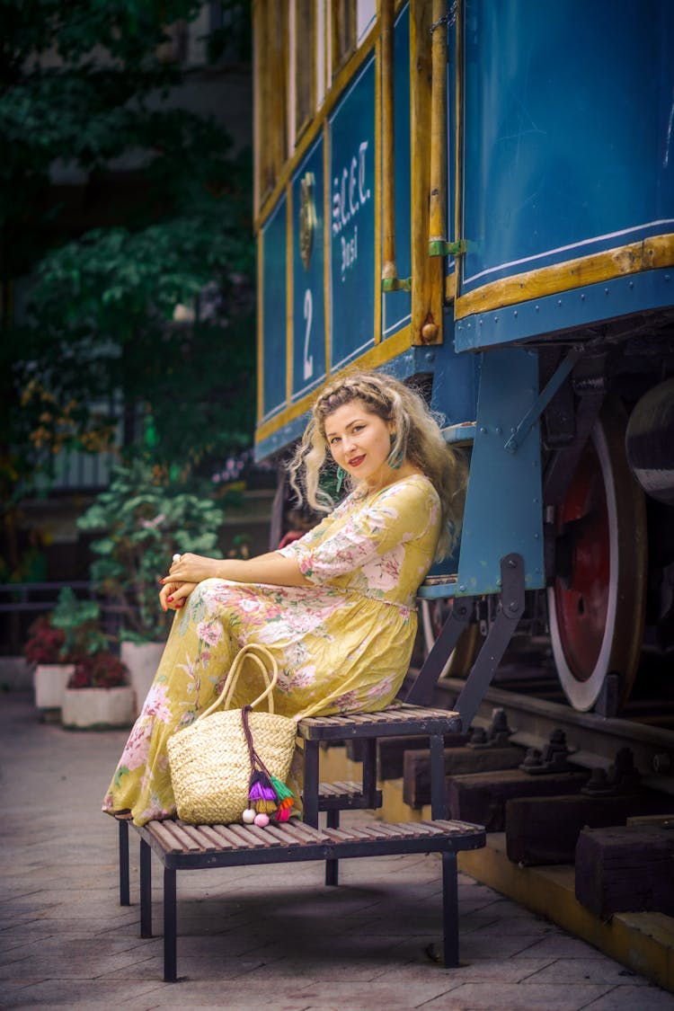 Woman In Yellow Dress Sitting Near Train