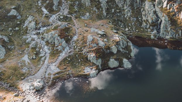 Stunning aerial shot of rocky landscape by a lake in Chamonix, France.