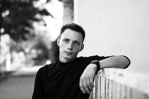 handsome man leaning on a Railing