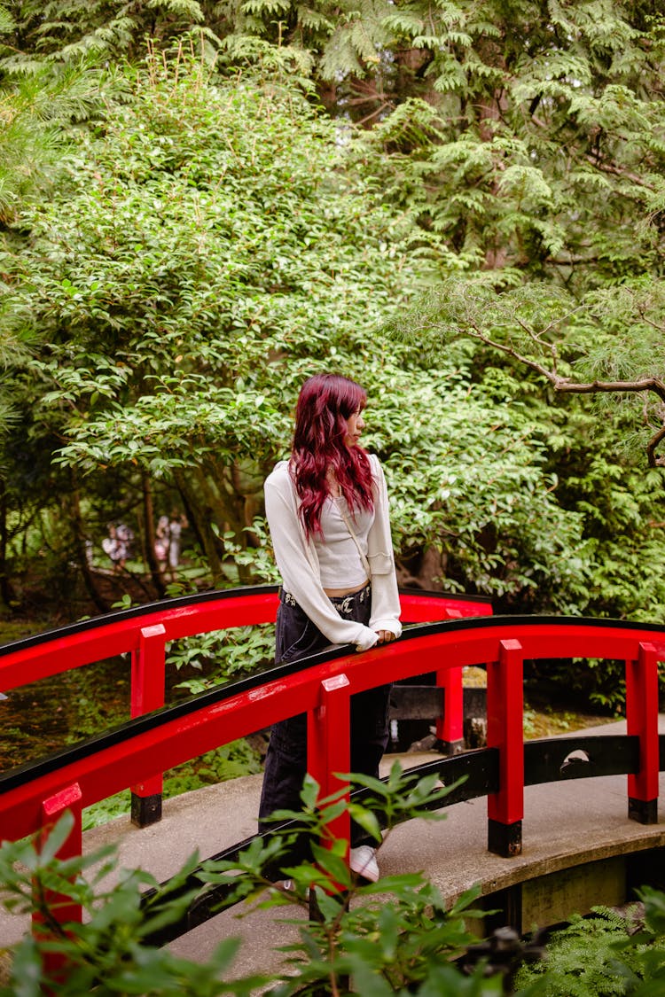 Woman On Footbridge In Park