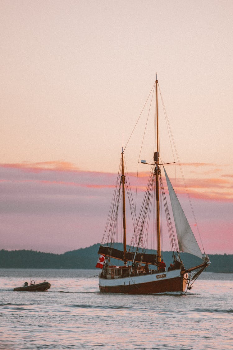 Ships With Sails Towing Motorboat