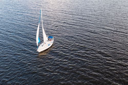 White Boat Sailing On Body Of Water · Free Stock Photo