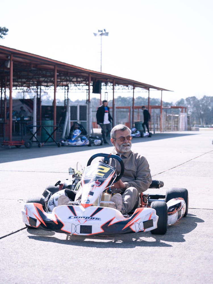 Elderly Man Riding A Go Kart