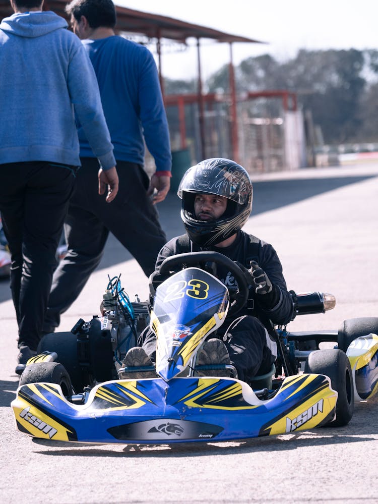 Man Wearing A Helmet Driving A Go Kart