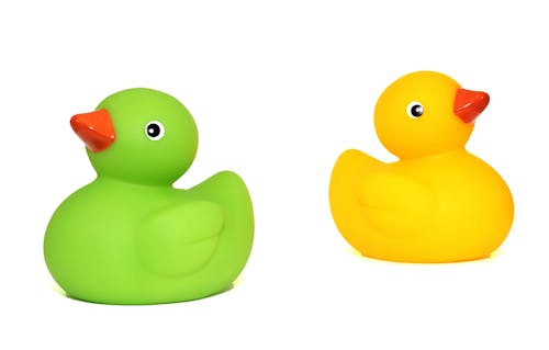 Free Yellow Duck Toy Beside Green Duck Toy Stock Photo