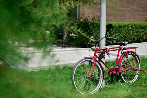 Free Red City Bike Parked on Sidewalk Stock Photo