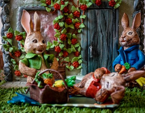 Free Close-up of colorful clay rabbit figurines in a vibrant garden setting, capturing a whimsical and artistic scene. Stock Photo
