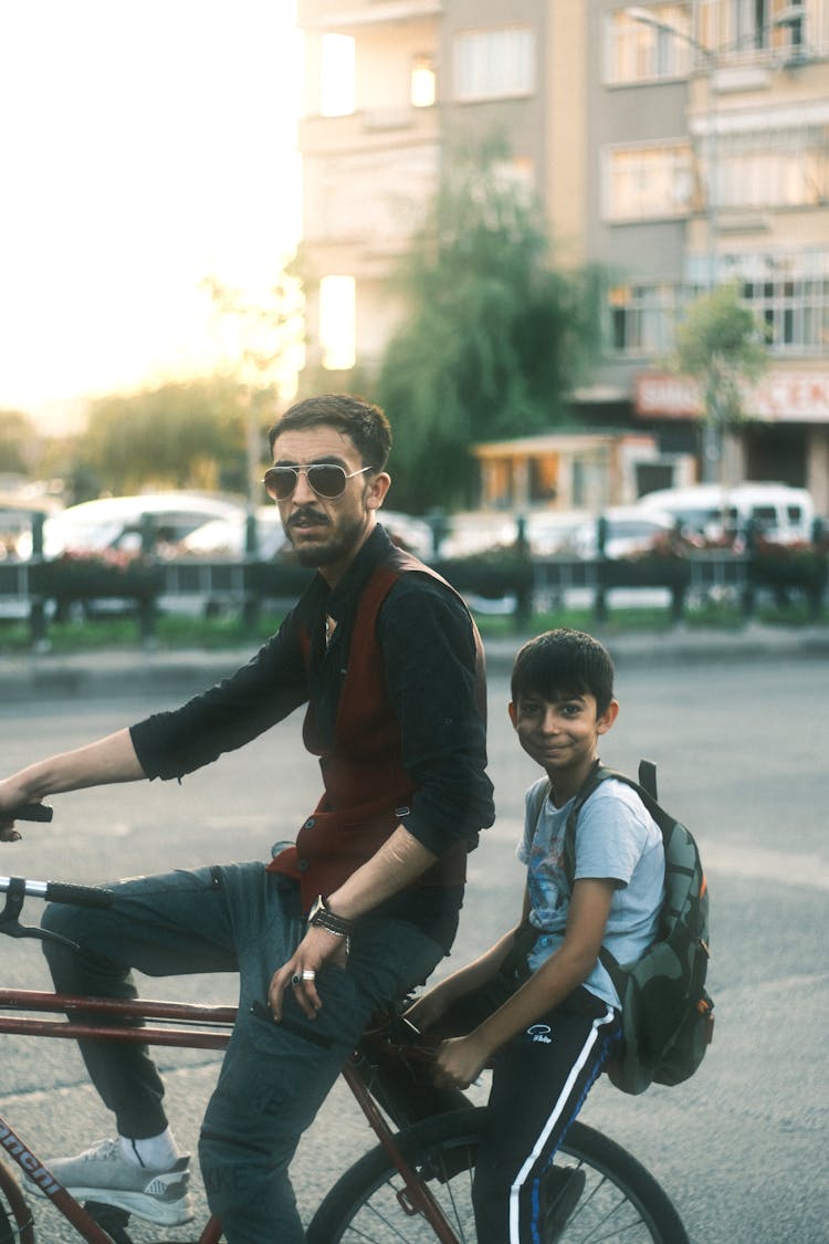 Father And Son Riding Bike