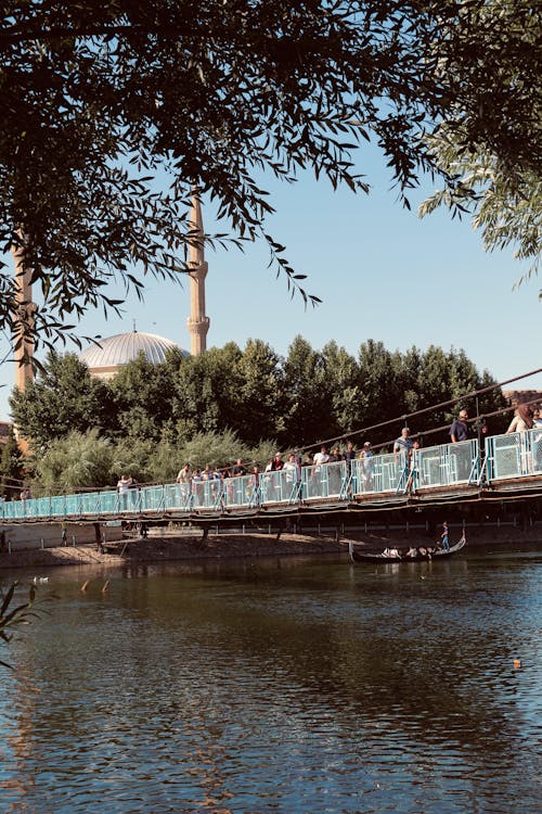 Footbridge over a River, and a Mosque in Background