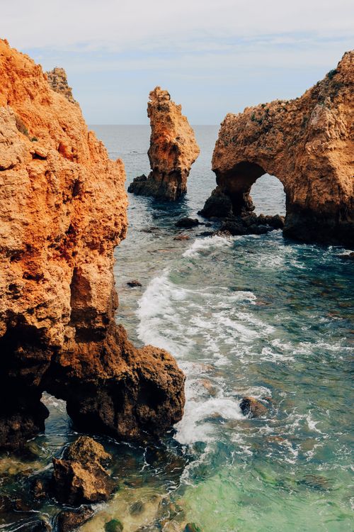 Free Explore the stunning rock formations of Ponta da Piedade in Lagos, Portugal, with its unique arches and clear ocean water. Stock Photo