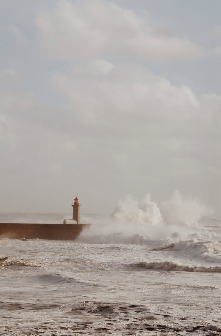 Photo Of A Seacoast With A Lighthouse 