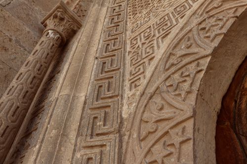 Free Close-up of intricate stone carvings on historical architecture in Mustafapaşa, Turkey. Stock Photo