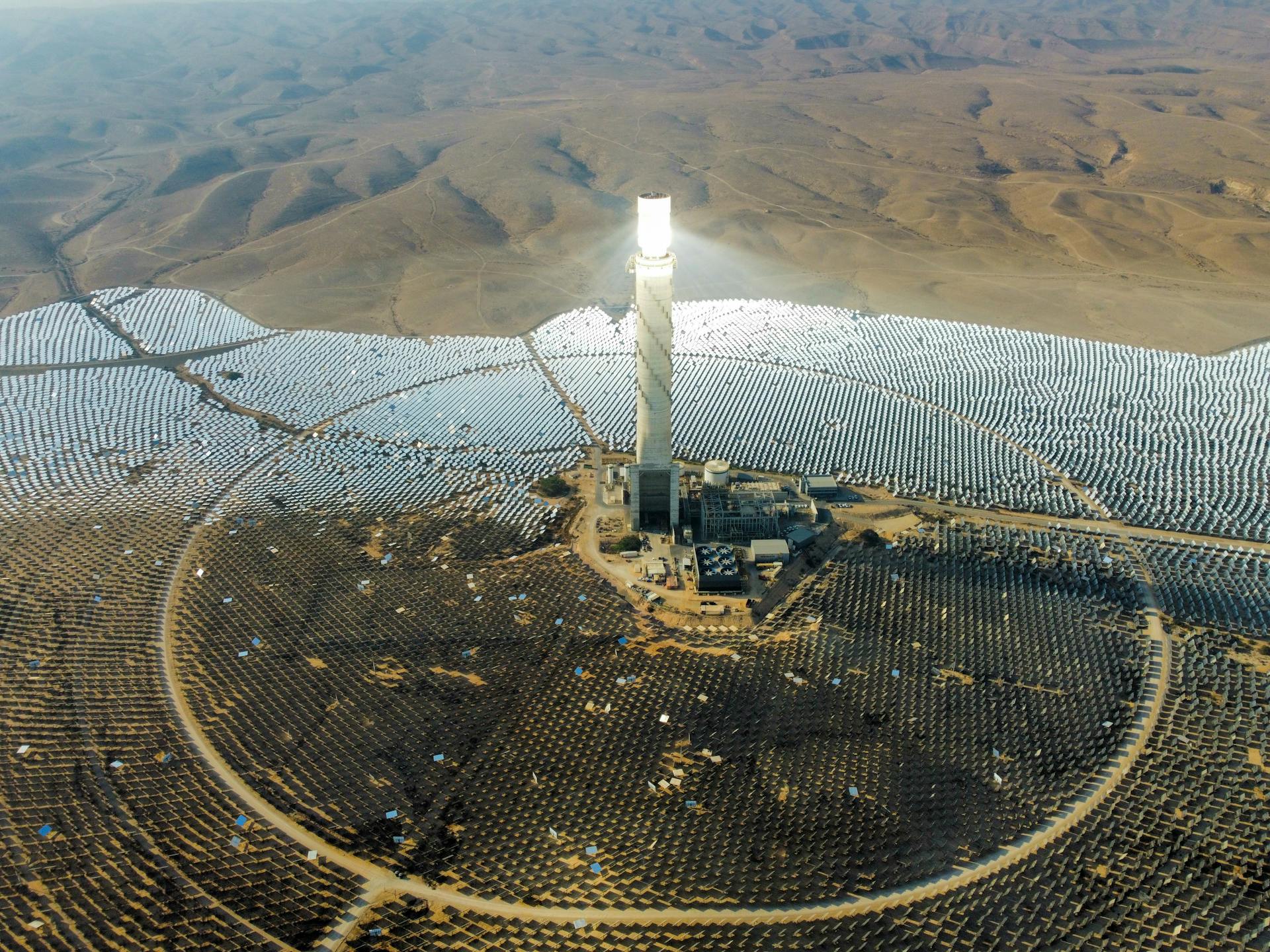 Aerial view of the Ashalim Power Station in Israel's Negev Desert harnessing solar energy with bright solar panels.