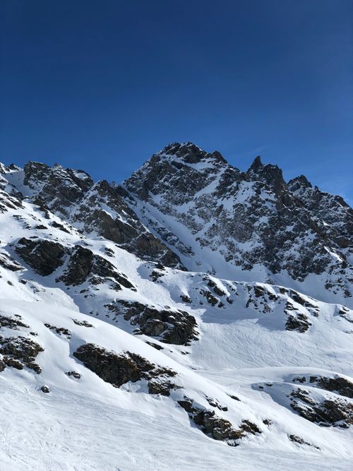 Free Stunning snow-covered mountains under a clear blue sky, perfect winter landscape. Stock Photo