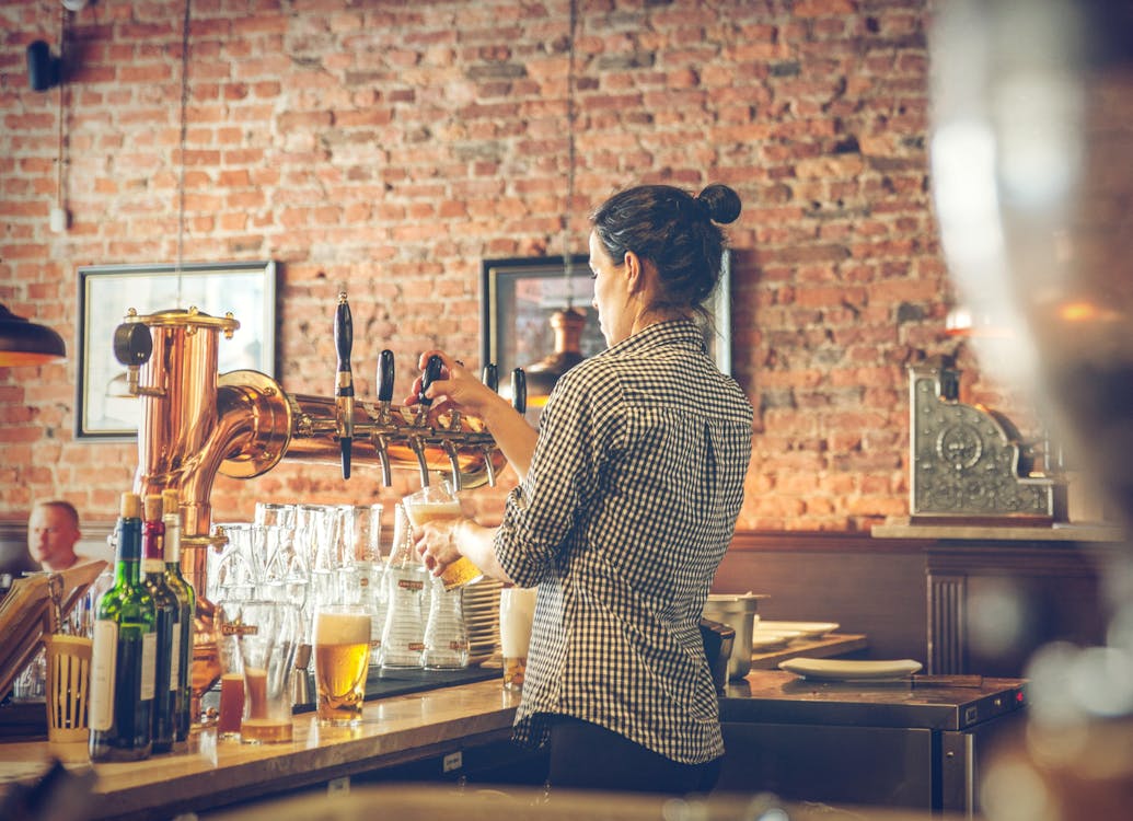 Free Photo of Bartender Pouring Draught Beer Stock Photo
