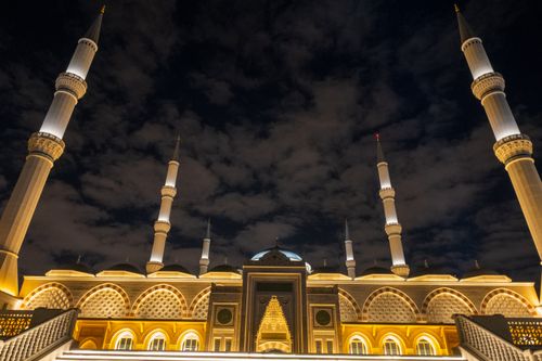 Free View of the illuminated Camlica Mosque under a night sky in Istanbul, Turkey. Stock Photo