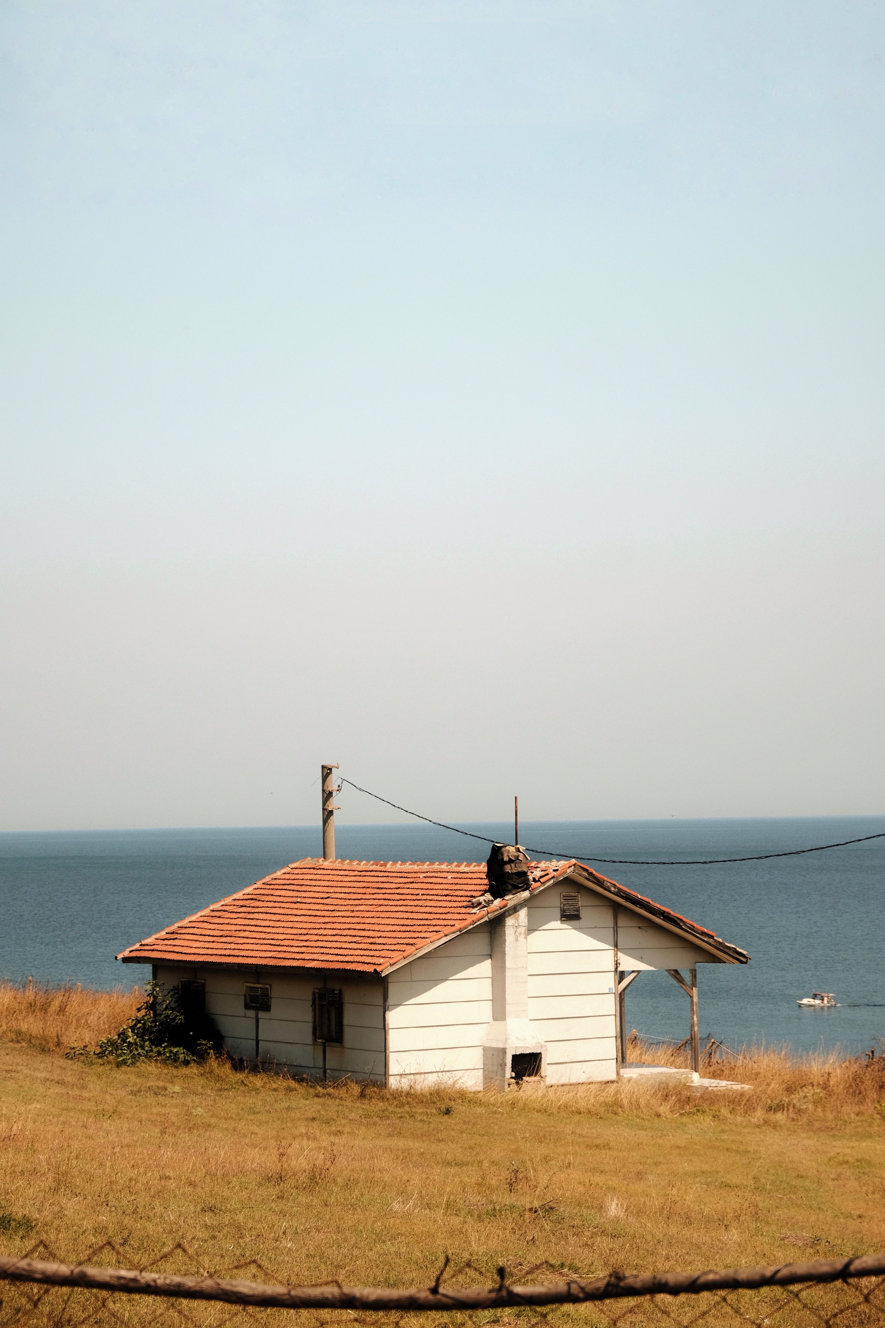 White and Brown Wooden House Near Body of Water · Free Stock Photo
