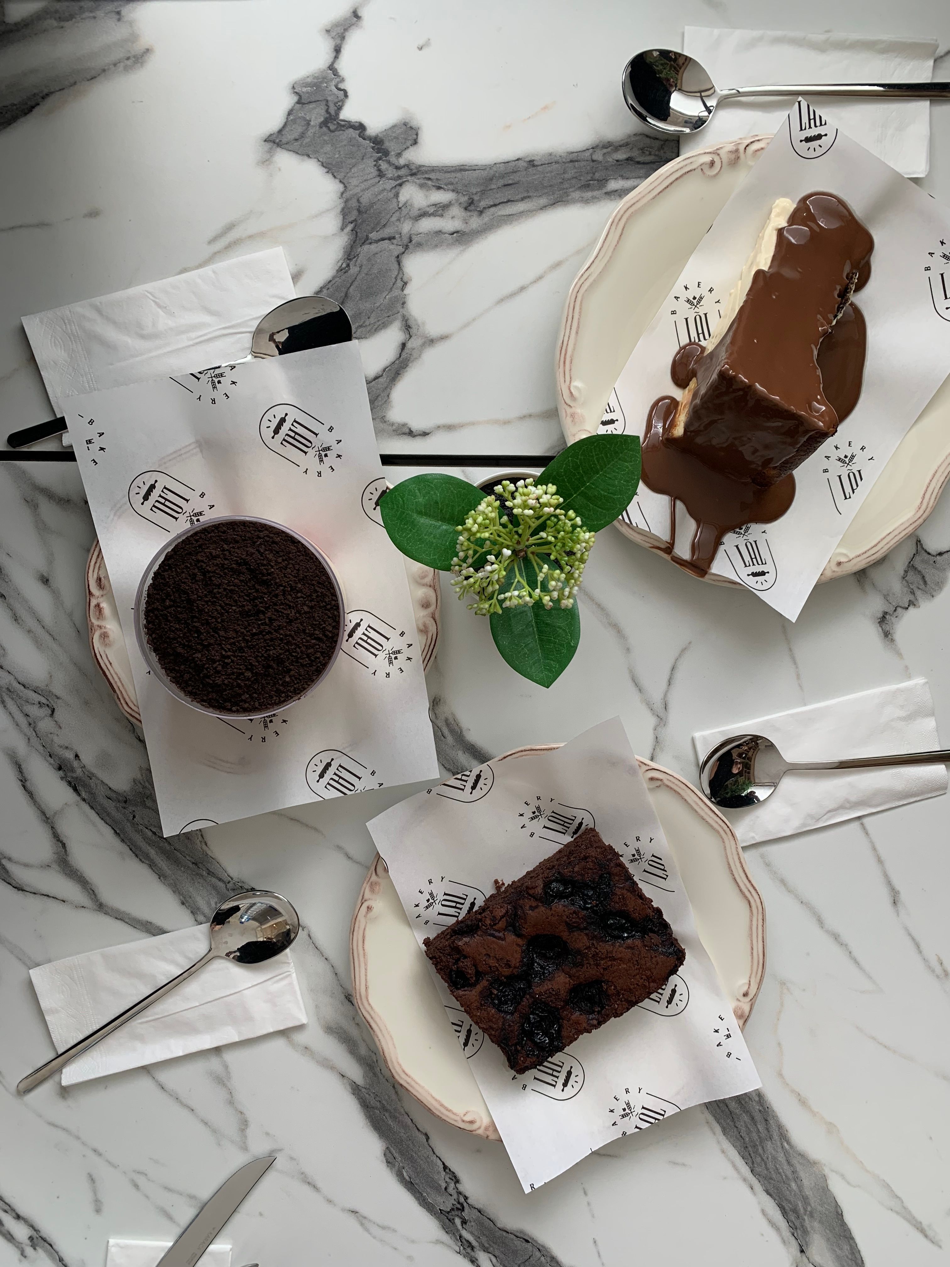 Top view of assorted chocolate desserts on a marble table with elegant presentation.