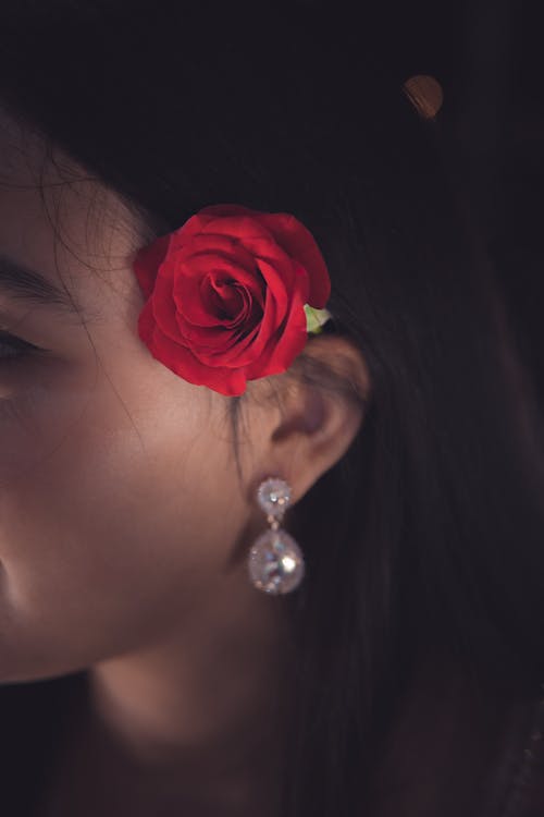 Free Red Rose on Women's Ear Stock Photo