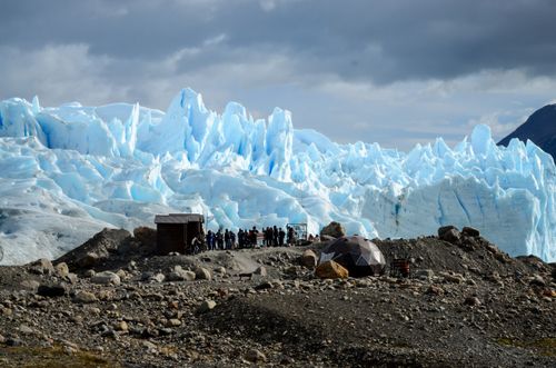 Free Tourists gather near the stunning Perito Moreno Glacier in Santa Cruz, Argentina. Stock Photo