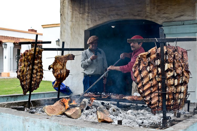 Man Preparing Food On Barbecue