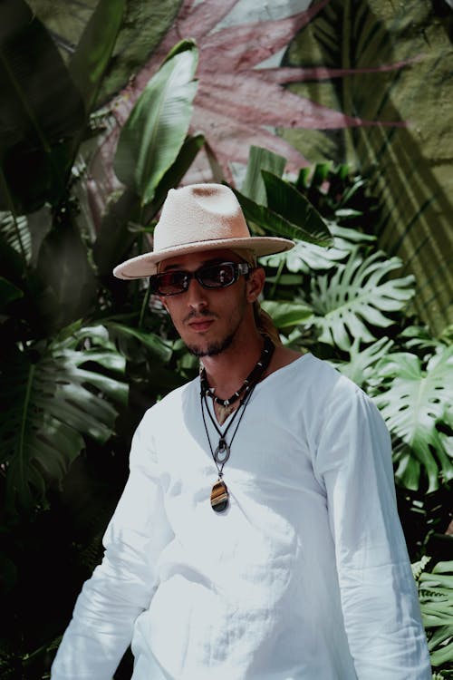 Man in White Long Sleeves Standing Beside Garden Plants