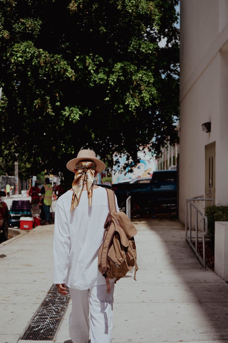 Man With Backpack Walking On City Street