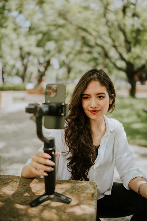 Free Woman Setting Her Smartphone with Tripod Stock Photo