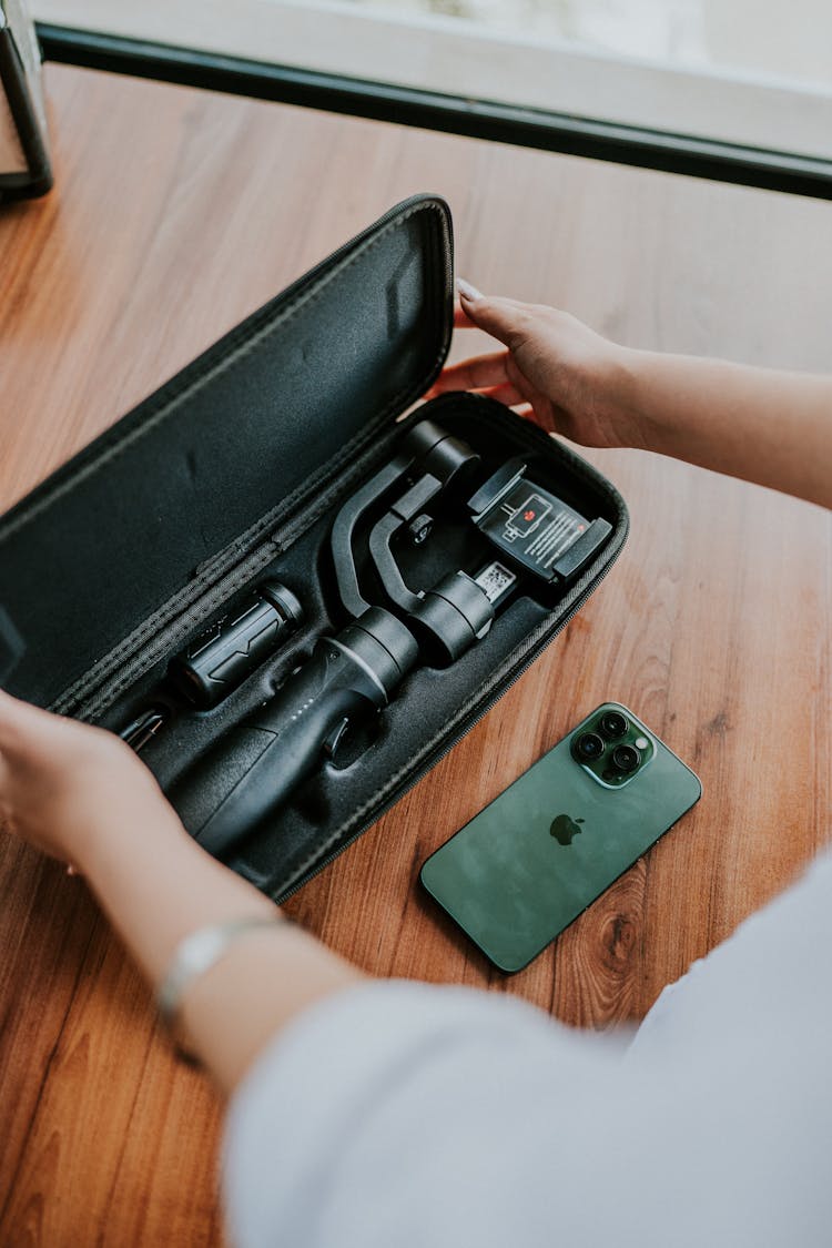 Hands Opening Box With Tripod