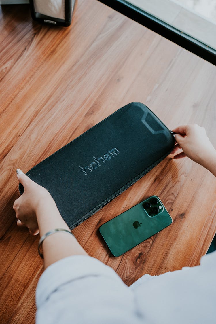 Woman Hands Holding Bag Near Smartphone