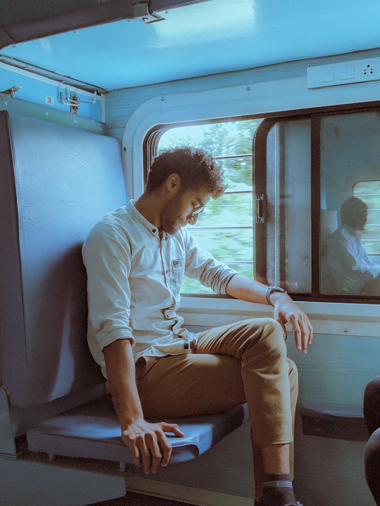 Young Man Asleep On A Train 