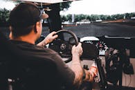 Man Driving Vehicle on Race Track