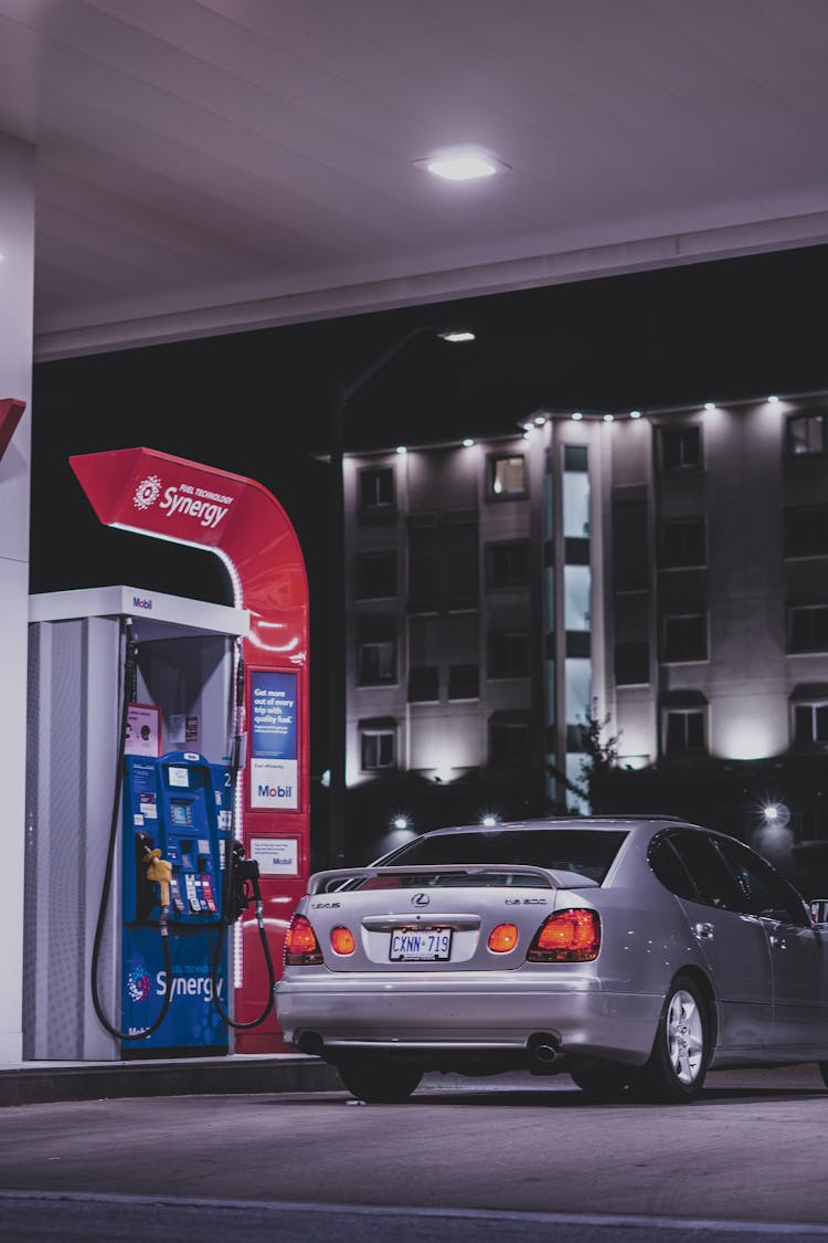 A Car Loading Gas In A Gasoline Station