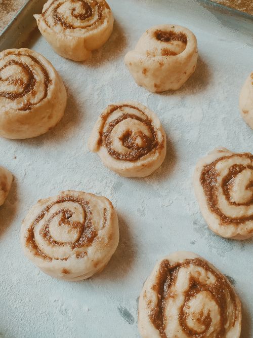 Free Close-up of unbaked cinnamon rolls on a floured baking tray, ready to bake. Stock Photo