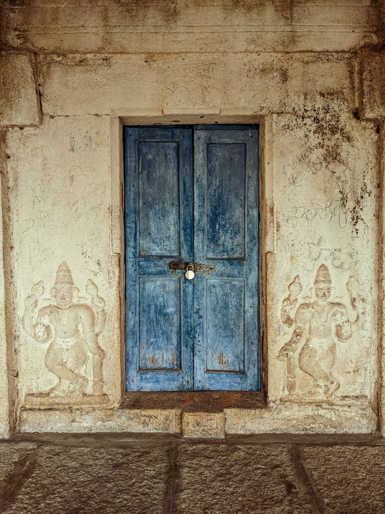 Old Wooden Blue Door And Carved Details On The Wall 