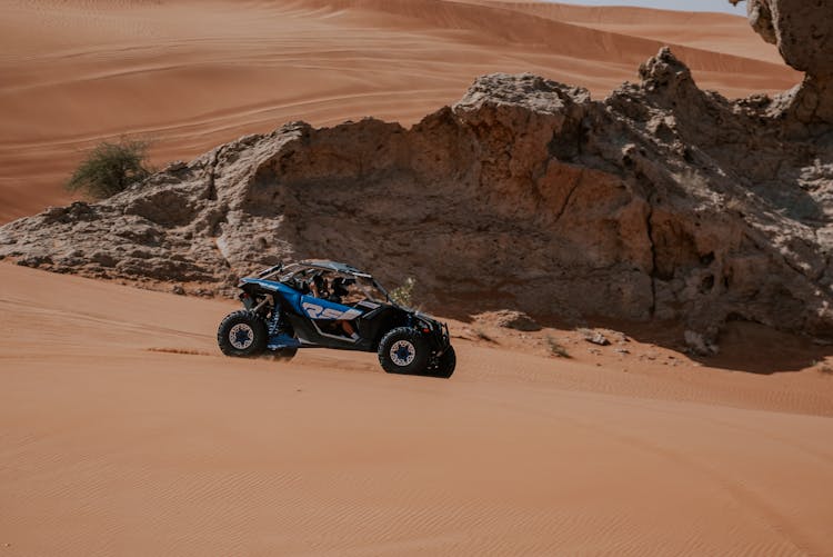 Blue And Black Dune Buggy On Sand