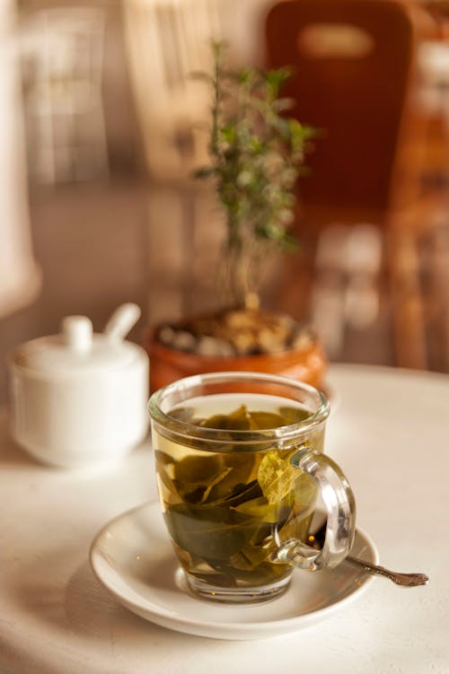 Clear Glass Cup in White Ceramic Saucer