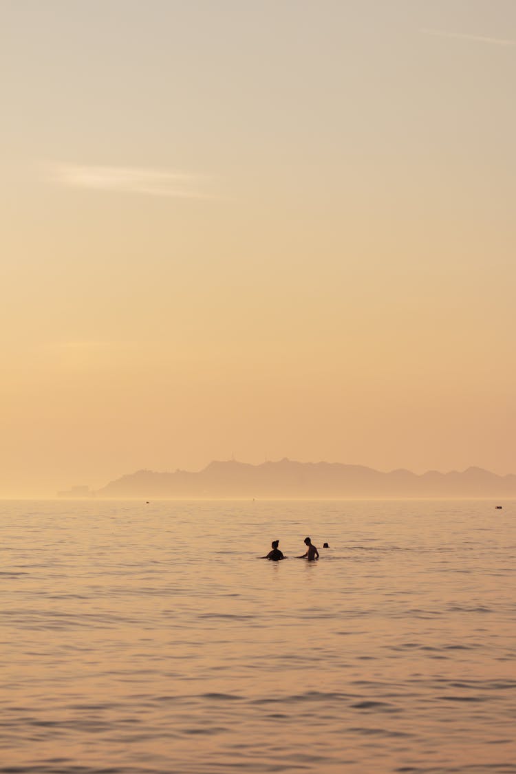 People On A Body Of Water Under A Gloomy Sky