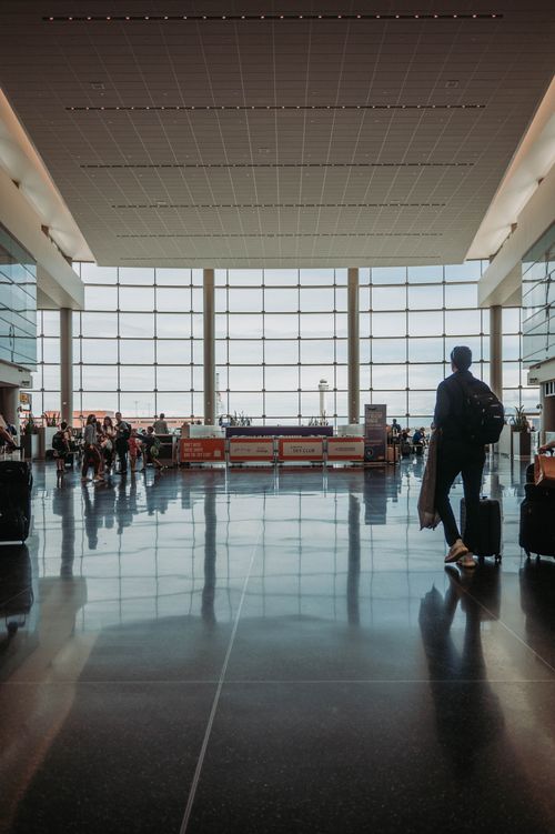 Free Busy airport terminal with travelers, luggage, and modern architecture. Stock Photo