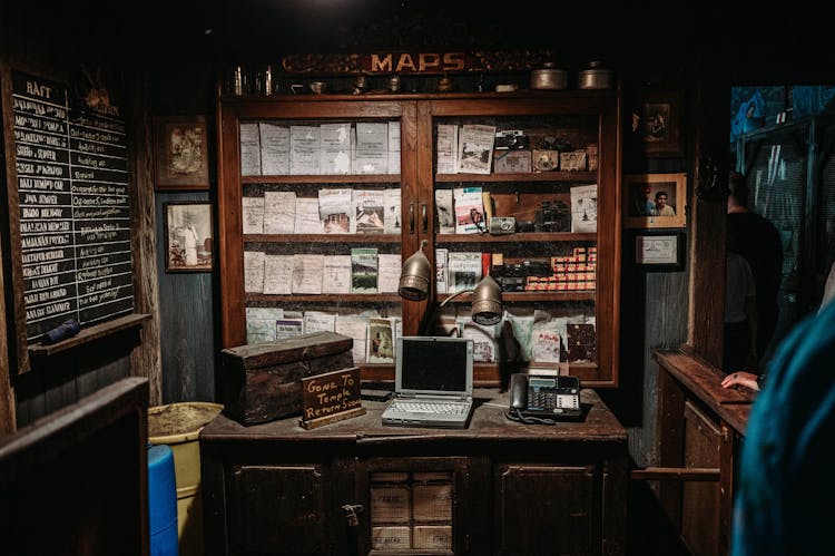 Laptop Computer And Telephone On Wooden Desk