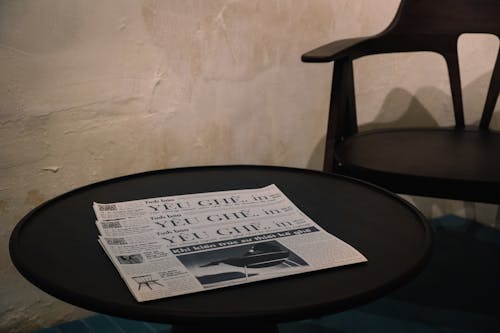 Newspapers on Black Round Table 