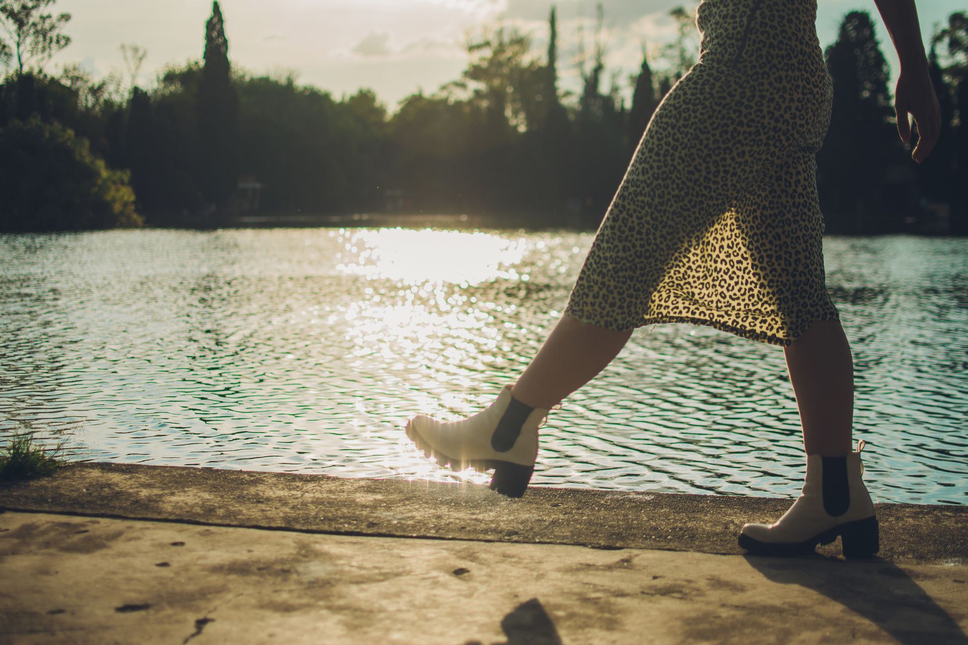 Leg and skirt by a lake, featuring white boots and animal print in Mexico City.