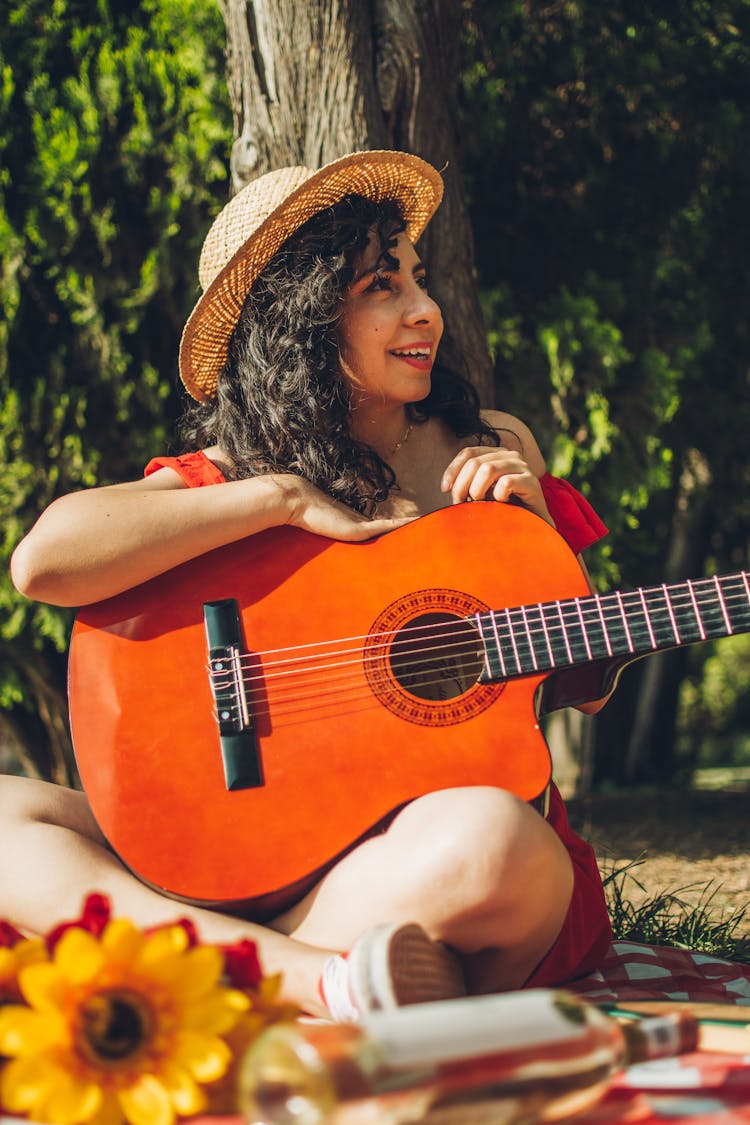 A Woman Holding A Guitar