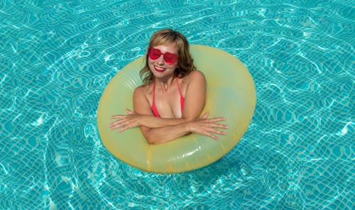 Smiling Woman in a Pool with an Inflatable Ring 